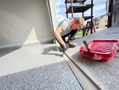 Maverick Concrete Coatings team member finishing a polyurea concrete coating