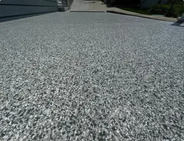 Decorative driveway concrete coating in flake finish