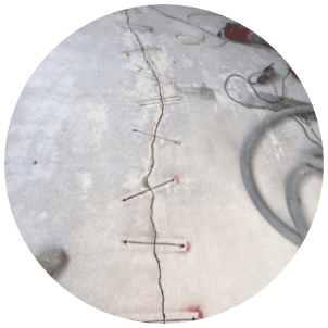 Cracked concrete icon representing the surface-condition factor in coating cost