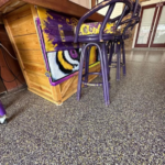 Basement floor with moisture-resistant concrete coating
