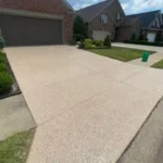 Residential driveway protected with high-traffic concrete coating