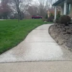 Residential walkway with crack-resistant concrete coating