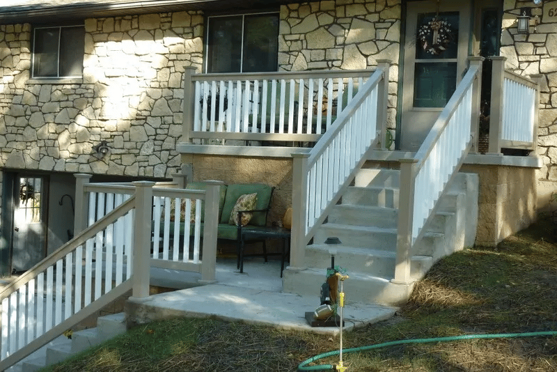 White vinyl stair and porch railings on a stone home.