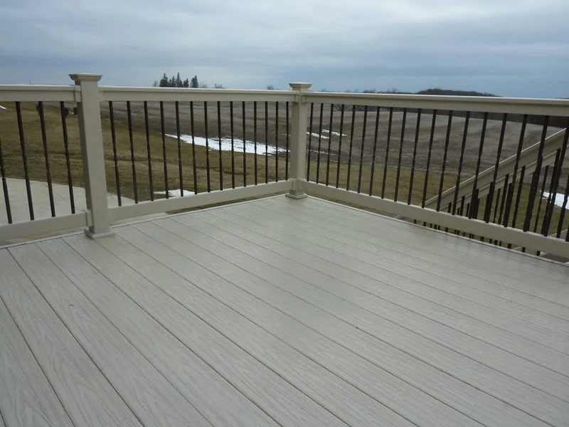 A grey deck with black aluminum railing.