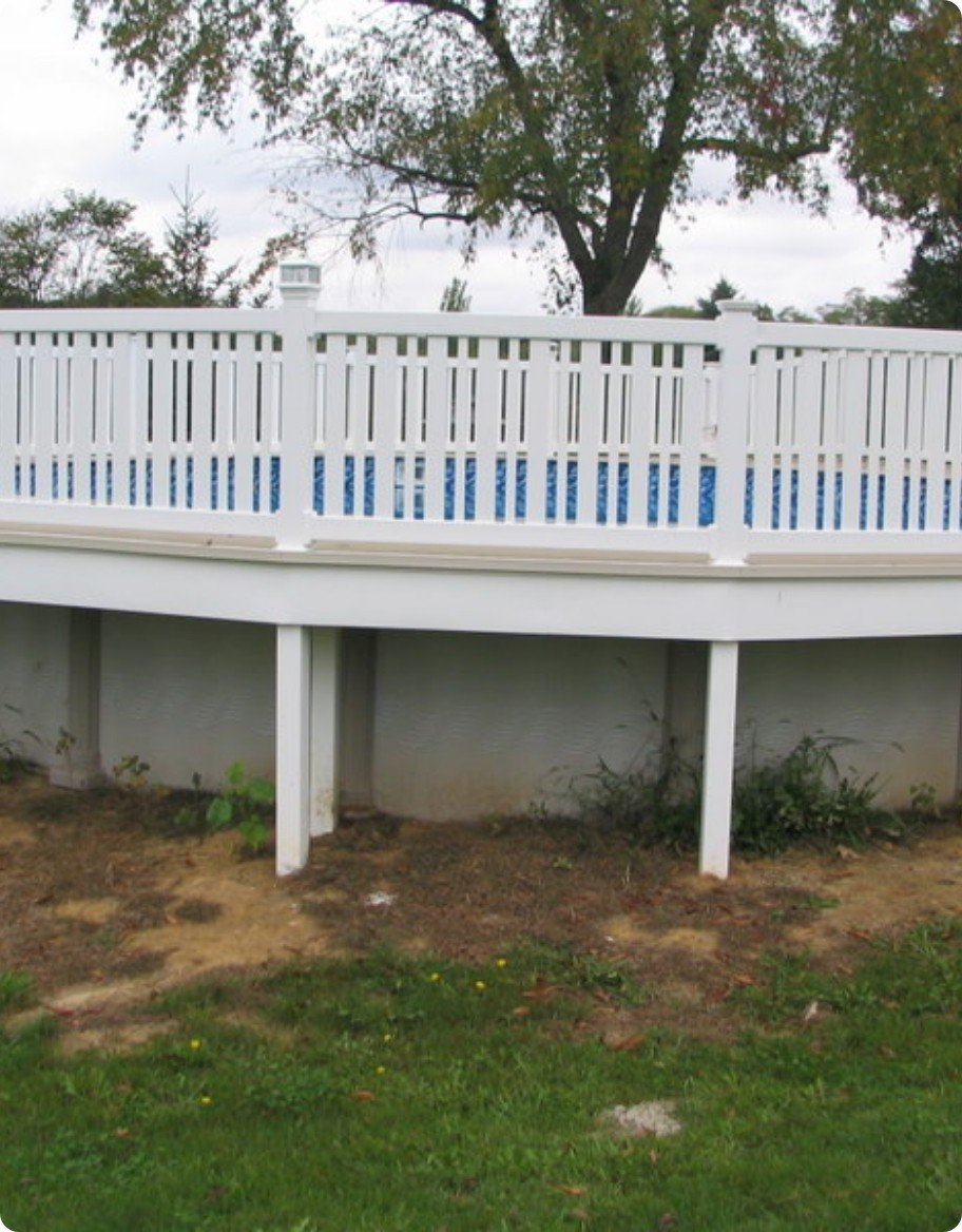 An above ground pool ringed with vinyl railings.