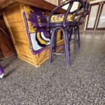 Basement floor with moisture-resistant concrete coating