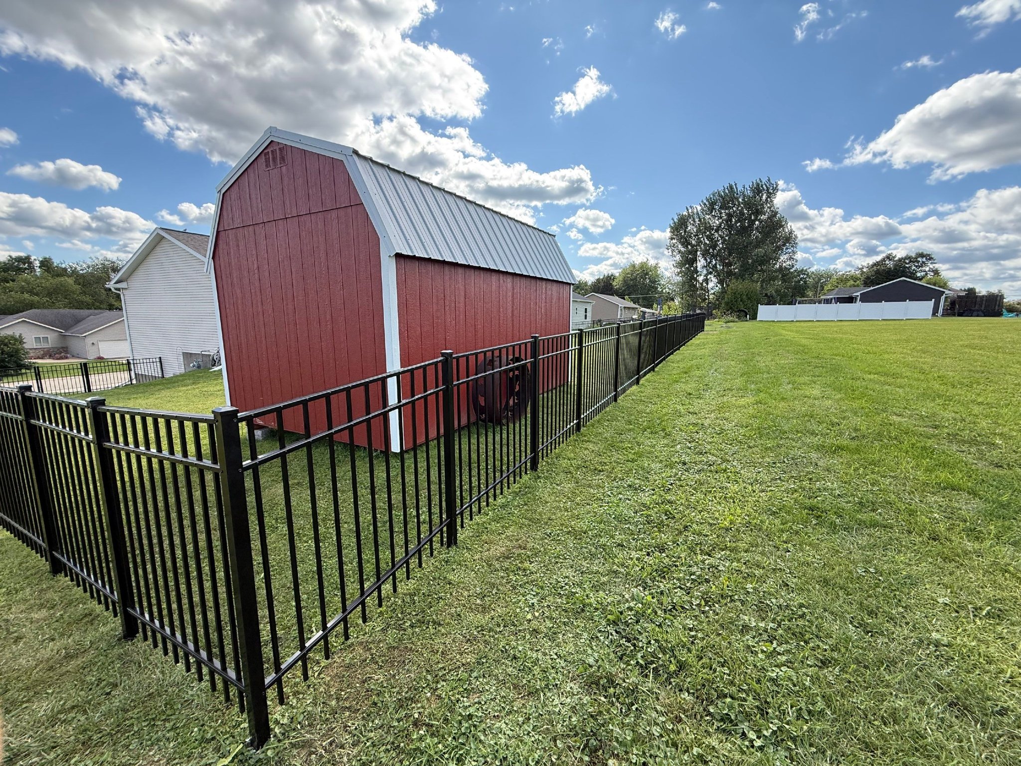 Metal Fences vs. Wood & Vinyl: A Complete Guide